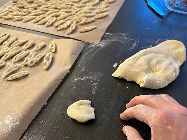 Hand-rolled cavatelli resting on a semola-dusted tray.