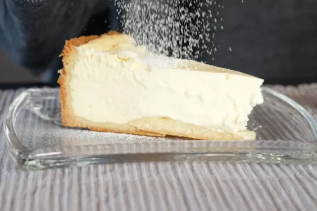 Slice of German cheesecake on a vintage dessert plate.